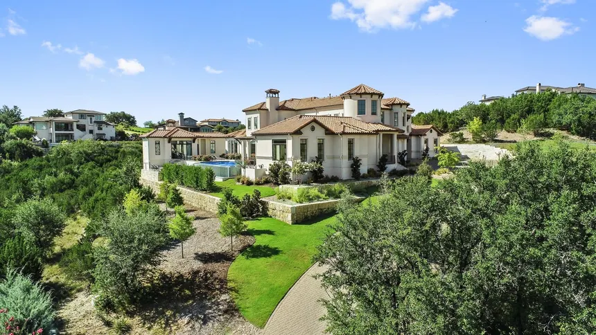 Custom limestone and glass estate on a gated Spanish Oaks golf course homesite